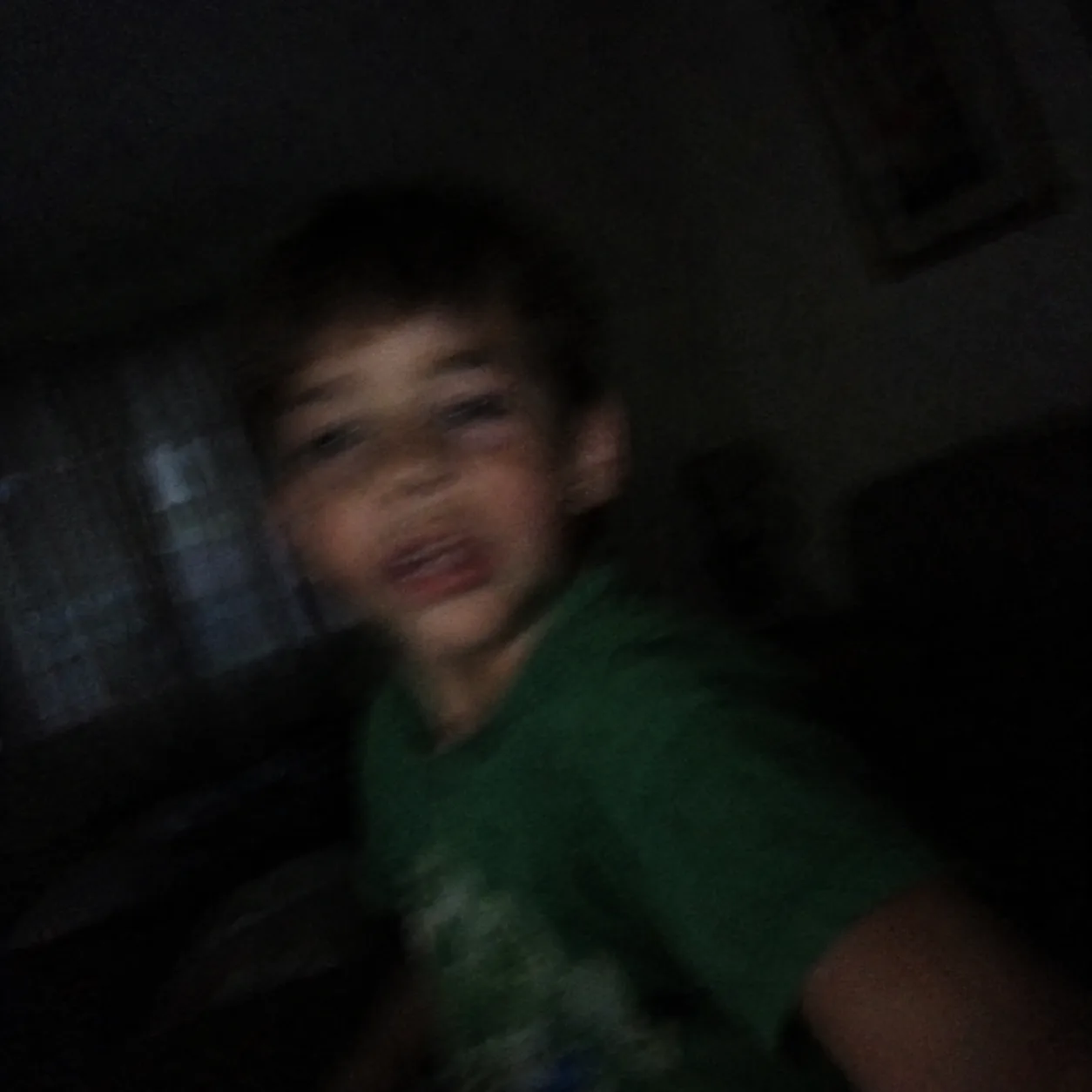 A blurry, dark photo of a child