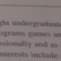 A motion-blurred racing car on a track with soft edges and directional streaks, illustrating typical motion blur before AI correction.